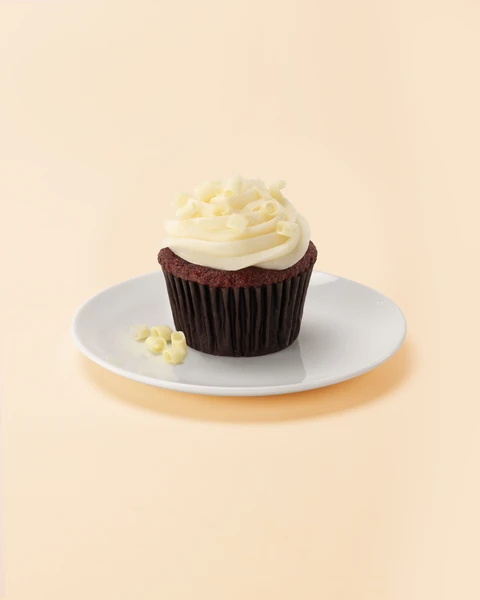 The Cheesecake Factory Bakery Red Velvet Medium Cupcake — single cupcake on a plate