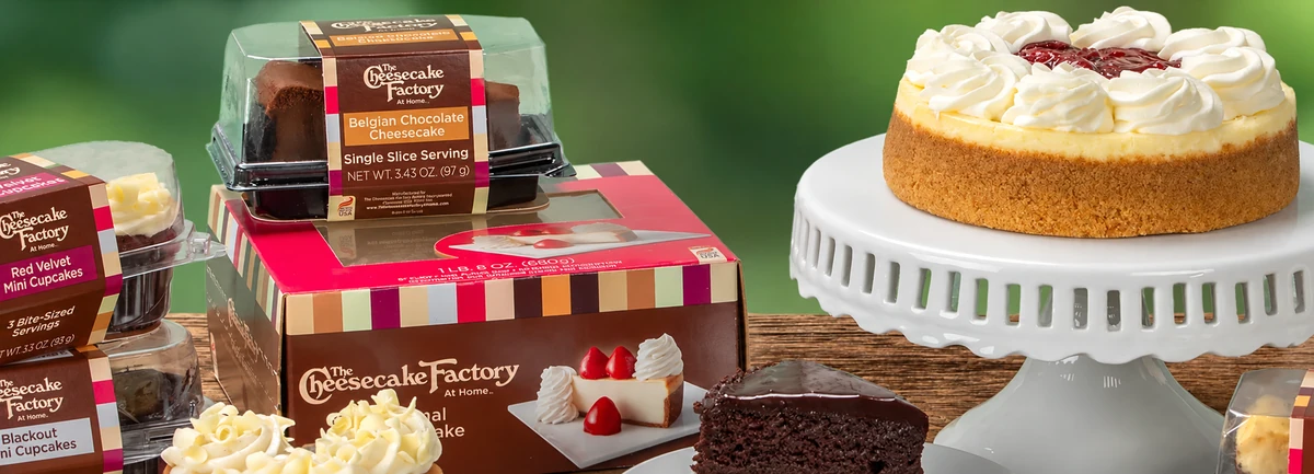 The Cheesecake Factory At Home packaged desserts displayed against a green background