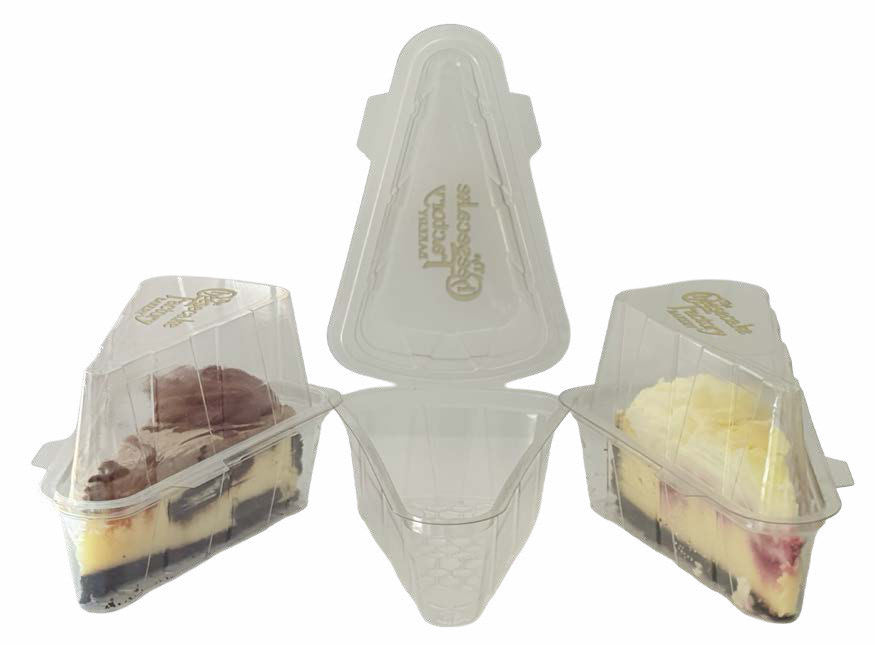 Clear triangular cheesecake slice containers, with one open container between two containers holding cheesecake slices